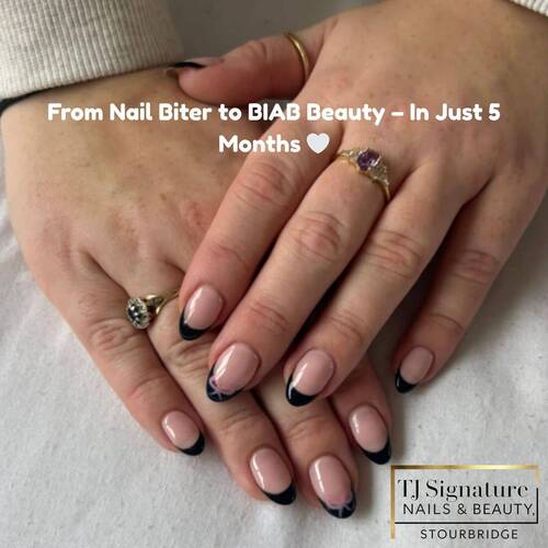 Soft nude base with sleek black French tips and delicate bow accents — timeless, chic, and feminine.